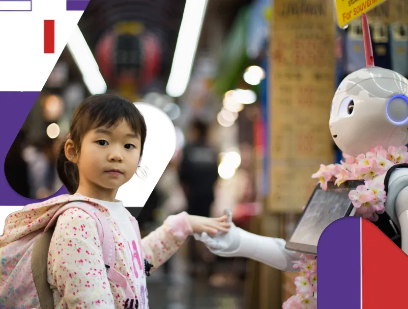 En liten asiatisk jente holder armen til en robot