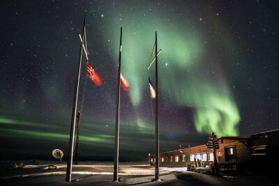 The Polish Polar station in Hornsund in Svalbard with Northern Lights in the background